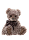 Charlie Bears Oryn collectible teddy bear with brown and cream-tipped fur, sculpted paws, and chocolate satin bow
