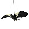 Hansa Flying Magpie plush toy with outstretched wings, soft black and white feathers, and realistic detail.