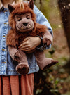 Quarry plush ogre from Charlie Bears Bear & Me 2025 collection with light brown fur, proud horn, embroidered paws, and friendly smile.