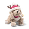 Steiff Rudy Christmas dog soft plush in light brown and cream with red Christmas hat, reindeer antlers and red collar, 27cm