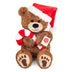 Teddy Hermann Christmas teddy bear wearing a festive hat and holding a candy cane.