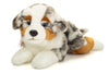 Teddy Hermann lying down Australian Shepherd plush toy with soft fur and realistic features